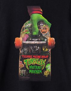 a skateboarder is holding his board with the words teenage mutant ninja on it