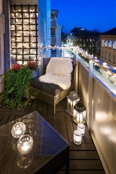 the balcony is lit up with candles and lights