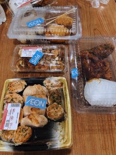 several plastic containers filled with food on top of a wooden table