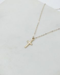 gold cross necklace, dainty cross necklace, gold necklace, cross necklace, dainty jewelry, gifts for her, religious necklace, gifts for women Dainty textured cross pendant necklace The prefect staple piece made to last! D E T A I L S: *Gold filled or sterling silver textured cross pendant 8x15mm *Dainty Gold filled or sterling silver cable chain- choose your perfect length at checkout SHIPPING: *Free domestic shipping on all orders over $35. PACKAGING: *All pieces come beautifully packaged, perf Dainty Crucifix Cross Necklace With Delicate Chain, Dainty Cross Necklace For Everyday, Simple Gold Cross Pendant Necklace, Gold Cross Necklace In 14k Gold Filled, Gold Cross Charm Necklaces In 14k Gold Filled, Gold Crucifix Charm Necklace In Minimalist Style, Gold Minimalist Crucifix Charm Necklace, 14k Gold Filled Cross Pendant Necklace, Minimalist Gold Crucifix Charm Necklace