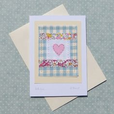 two greeting cards, one with a heart and the other with a flower border on it