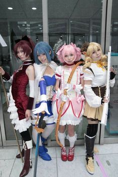 three anime cosplay standing next to each other