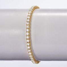 Ross-Simons - 10.00 ct. t. w. Cubic Zirconia Tennis Bracelet in 14kt Gold Over Sterling. 8". It's all about the big sparkle of CZs. This tennis bracelet takes full advantage with 10.00 ct. t. w. round brilliant-cut CZs in 14kt yellow gold over sterling silver. Double-latch safety. Box clasp, CZ tennis bracelet. CZ weights are diamond equivalents. Gold Iced Out Tennis Bracelet For Anniversary, Gold Iced Out Round Tennis Bracelet, Dazzling Crystal Tennis Bracelet With 17 Jewels, Diamond Cut Crystal Tennis Bracelet, Round Crystal Tennis Bracelet With Diamond Cut, Dazzling Cubic Zirconia Gold Bracelet For Anniversary, Dazzling Gold Cubic Zirconia Bracelet For Anniversary, Dazzling Gold Bracelet With Cubic Zirconia, Dazzling Cubic Zirconia Gold Bracelet