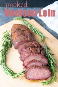 smoked venison loin on a cutting board with rosemary