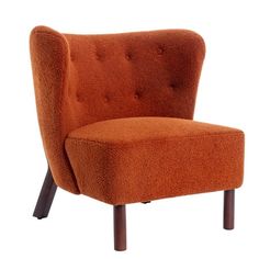 an orange chair sitting on top of a wooden legrest with a buttoned up back