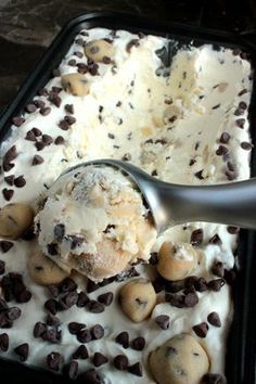 a scoop of ice cream with cookies and chocolate chips on it, in a pan