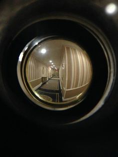 the reflection of an escalator in a metal object that looks like it is going down