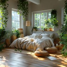 a bedroom with lots of plants in the window sill and bed linens on the floor