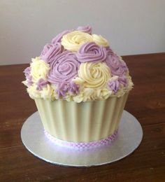 a cupcake decorated with purple and white frosting