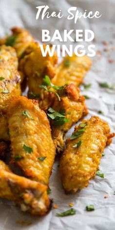 fried wings with herbs on top and the words, thai spice baked wings above them