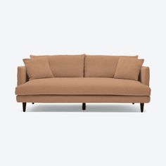 a tan couch with two pillows on the back and one arm folded out to show off