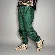 "Vintage Pro Player Track Pants Packers Green Yellow Nylon Joggers Elastic Cuffs has Ankle Zippers Lined 90s Skate / Streetwear Great Condition: 9/10 Men's Size: Large My Hands in Pockets = It has Pockets No Hands in Pockets = Does Not Have Pockets Drawstring Will be Visible in Forward Pic, if not Visible it Does Not Have a Drawstring About me: I am 6' 0\" for reference I generally wear a Large (32\" inseam) I Model XS to 2XL sweatpants, I find that you can often size up or down with 95% of sweatpants and they fit the same" Green Parachute Pants For Streetwear, Green 90s Style Streetwear Bottoms, Green Parachute Pants For Spring Outdoor Activities, Green Parachute Pants For Outdoor Spring Activities, Green Parachute Pants For Spring Outdoor, Retro Stretch Pants For Streetwear, Retro Green Bottoms For Streetwear, Sporty Green Parachute Pants For Outdoor Activities, Green Sporty Parachute Pants For Outdoor Activities