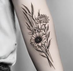 a black and white photo of flowers on the arm