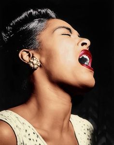 a woman with her mouth open wearing earrings