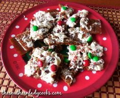 a red plate topped with christmas treats on top of a table