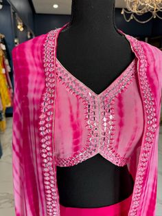 TO ORDER LARGER SIZES, PLEASE WHATSAPP +1 (945) 444-2194 Pink tie-die handwork Pallazo accentuated with beautiful real mirror work. Crafted with beautiful V-shaped neckline and beautifully embroidered cardigan with real mirror work. paired with a trendy pallazo style bottom. Slight variation in color is possible due to digital photography. Shipping will take 2 weeks,Please WHATSAPP +1 (945) 444-2194 for more info. Traditional Front Open Embellished Sets, Traditional Embellished Front Open Sets, Bohemian Pink Salwar Kameez With Mirror Work, Festive V-neck Sets With Mirror Work, Designer Wear Summer Sets With Mirror Work, Summer Embellished Georgette Dupatta, Embellished Georgette Dupatta For Summer, Designer Mirror Work Sets For Summer, Bohemian Palazzo Set With Mirror Work