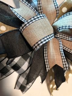 a black and tan plaid bow with polka dots