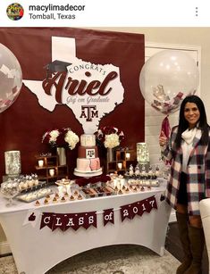 a woman standing next to a table filled with desserts