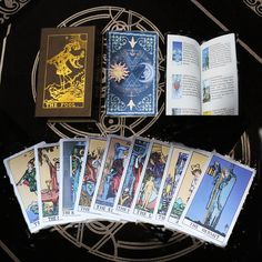 the tarot cards are laid out in front of an open book