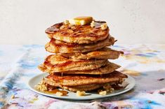 a stack of pancakes sitting on top of a white plate