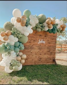 a wooden box with balloons attached to it