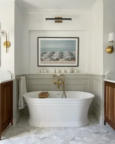 a white bath tub sitting in a bathroom next to a sink