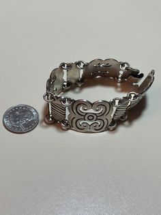 "This is a stunning, vintage, handmade Taxco sterling silver bracelet that has a beautiful, ornate Art Nouveau feel to it. The bracelet is about 8 inches. It is very hard to find these gorgeous Taxco bracelets in larger sizes like this one. It is very well-made and is about 1 1/8\" in width. It has an older style sterling silver hook clasp. The bracelet weighs a hefty 73.6 grams. It is stamped Mexico 925 with a faded Taxco hallmark/logo. Very pretty and well-made. See pictures for details. More Handmade Sterling Silver Collectible Bracelet, Ornate 925 Sterling Silver Bracelet, Ornate 925 Stamped Bracelet Jewelry, Vintage Sterling Silver Bracelets With Intricate Design, Vintage Sterling Silver Bracelet With Intricate Design For Anniversary, Bohemian Sterling Silver Bracelet Stamped 925, Collectible Sterling Silver Antique Bracelet, Bohemian Sterling Silver Bracelet For Anniversary, Silver Bohemian Bracelets For Anniversary