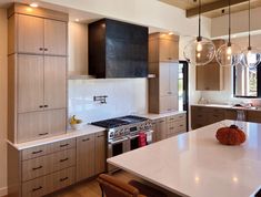 a large kitchen with an island, stove and oven in it's center area