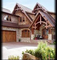 a large house with stone and wood accents