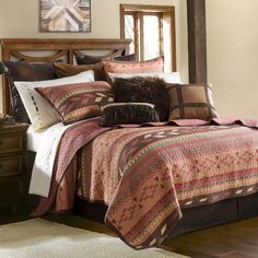 a bed in a room with a wooden headboard and pillows on top of it