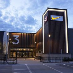 the entrance to a large building with a yellow and white number 3 on it's side