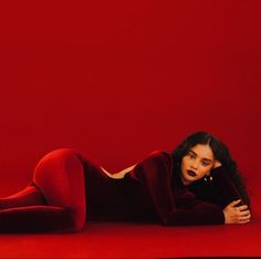 a woman is laying on the floor with her legs spread out and looking at the camera