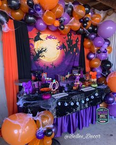 an outdoor halloween party with balloons, decorations and table cloths on the outside wall