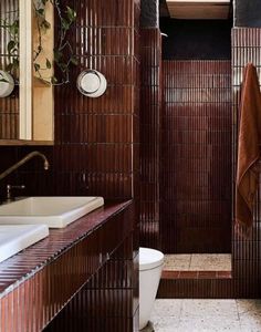 a bathroom with brown walls and tile flooring