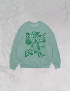 Start Rocking Around the Christmas Tree in our super cozy oversized sweatshirt, just in time for the Holiday season!- Features a Christmas party with the phrase "Rocking Around the Christmas Tree" around it all in a deep green ink- Screen print transfer that is individually heat pressed onto each sweatshirt- Printed on a soft 90's style, cotton / poly blend sweatshirt- Cotton / Poly Blend- Oversized fit- Sizing translation: XS/S - L , S/M - XL , L/XL - 2XL , 2XL/3XL - 3XL Rocking Around The Christmas Tree, 90s Sports, Screen Print Transfer, 90s Sweatshirt, Print Transfer, Western Chic, Sporty And Rich, Oversized Sweatshirt, British Indian Ocean Territory