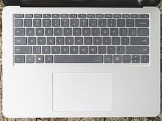 an open laptop computer sitting on top of a wooden table