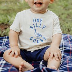 This One Silly Goose fine jersey baby tee is the perfect shirt for your Silly Goose 1st birthday party! These 100% Cotton tees are soft, comfortable and will be the cutest party shirt for your 1 year old. -100% Cotton -True To Size -Comes in TSHIRT sizes 6M-24M CARE .Turn inside out to wash, with like colors on cold delicate cycle .Non-chlorine bleach to wash .Tumble on low to dry or hang .No ironing or dry cleaning ORDER PROCESSING Each tee is made to order and printed as each order is placed. Spring Birthday Short Sleeve Top, Spring Short Sleeve Birthday Top, Short Sleeve Tops For Spring Birthday, Family Matching Cotton Tops For Birthday, Family Matching Cotton Shirt For Birthday, Number Print Tops For Birthday With Short Sleeves, Sporty Short Sleeve Top With Number Print For Birthday, Birthday Tops With Short Sleeves And Number Print, Crew Neck Cotton Top For Birthday