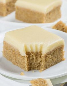 a piece of cake sitting on top of a white plate next to another slice of cake