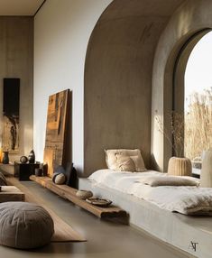 a living room filled with lots of furniture next to an arched window on the wall