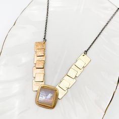 Limited edition. Lightweight, textured movable squares in 18k vermeil that have been riveted on the back make up this fun necklace. Accented with a square rose cut Rainbow Moonstone. oxidized silver chain with lobster clasp with an adjustable length from 16-18in earnings measure 1”. Sold separately Each piece is framed in 24k gold over silver using the meticulous Korean Keum-boo technique. This ancient technique enhances the earrings with a rich, golden luster, symbolizing wealth and timeless beauty. Keum Boo, Cool Necklaces, Oxidized Silver, Necklace And Earrings, Rainbow Moonstone, Bridal Collection, Ring Bracelet, Earring Necklace, Rose Cut