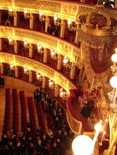 an overhead view of a theatre with red seats and chandeliers