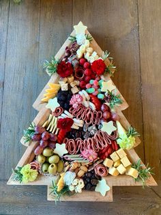 a christmas tree made out of fruits and cheeses