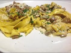 two pasta dishes with mushrooms and cheese on a white plate