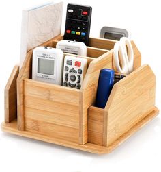 a cell phone and remote control in a bamboo holder