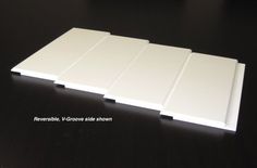 four white tiles sitting on top of a black table