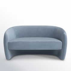 a blue couch sitting on top of a white floor