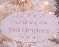 a pink christmas tree with a white sign on it that says, i'm dreaming of a pink christmas