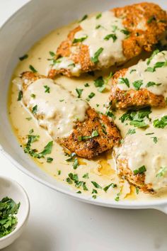 chicken parmesan with gravy in a white bowl