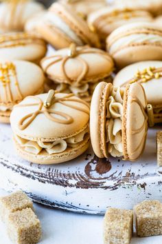 some cookies that are sitting on a table with gold trimmings and small pieces of biscuit next to them