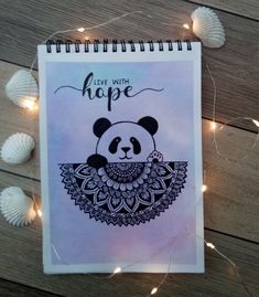 a spiral notebook with an image of a panda bear on it and the words live with hope written in cursive writing